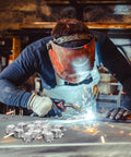 Welder using 24 Pack Butt Welding Clamps Pro Grade for Edge to Edge Welding on auto body panel, sparks flying in workshop