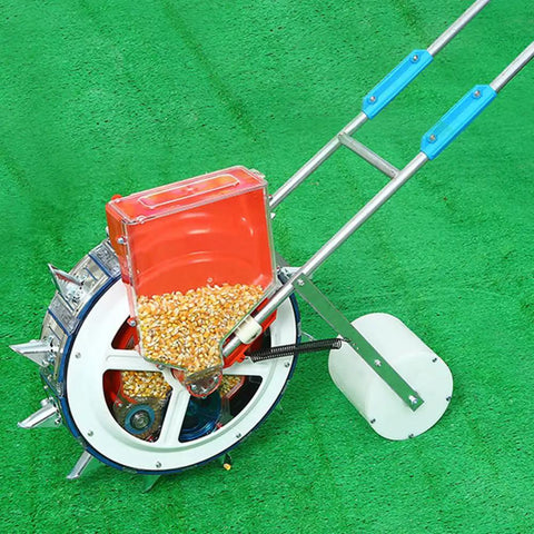 Walk Behind Garden Seeder With 16 Outlets For Easy No Fuss Planting, showing corn seeds in hopper, on green grass