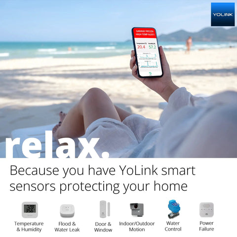 Person holding smartphone with LoRa monitoring app on beach, showcasing Smart Power Fail Alarm And Hub Kit With AC Power Outage Alerts.