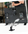 Back view of Pro Grade Repair Clip Magnifying Mirror And PCB Holder in use, showing flexible arms and magnifying glass.