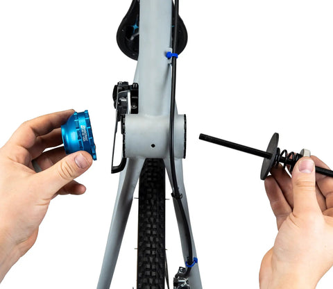 Hands using Bottom Bracket Retaining System With Double Sided Adapter Nut For Cartridge BBs No Slip Clamping on bike