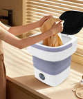 Hella Efficient Compact Foldable Mini Washer With Slick Drainage Setup And Pure Copper Motor Plus Gentle Handwash Simulation For Delicates And Baby Clothes Green Finish with clothes being loaded.