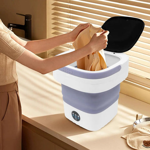 Hella Efficient Compact Foldable Mini Washer With Slick Drainage Setup And Pure Copper Motor Plus Gentle Handwash Simulation For Delicates And Baby Clothes Green Finish with clothes being loaded.