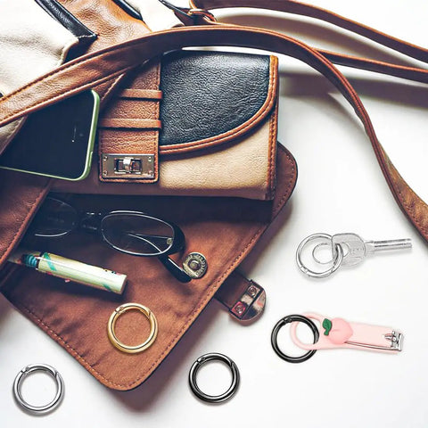 Purse with 24 Pack Mini Locking Carabiners For Keychains Rings 1.0 Inch Small Clips set in gold, silver, black on display