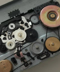 Close-up of cassette recorder mechanisms with 50 Pcs Cassette Recorder Rubber Belts Repair Kit 1mm Wide Fits 40 To 135mm Mix