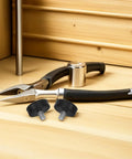 12 Piece Adjustable Furniture Leveling Feet With M10 Screw Thread next to pliers on wooden surface