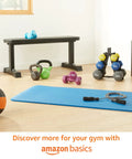 Rock Solid Cast Iron Kettlebell Thirty Five Lb Weight With Wide Comfort Grip on gym floor surrounded by other weights and equipment.