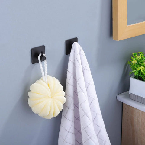 Stick On 16 Inch Towel Bar With Two Adhesive Hooks Black Stainless Steel Bathroom Rack holding towel and sponge