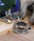 2pcs Heavy Duty Steel Drill Coil Springs Built For Durability And Elasticity Perfect Replacement For Milling Machines And Drilling Equipment Easy Installation Ensures Stability In Industrial Mechanical Workflows beside a jigsaw on wooden surface.