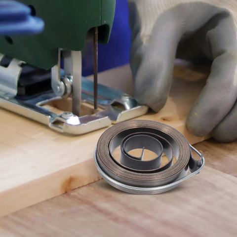 2pcs Heavy Duty Steel Drill Coil Springs Built For Durability And Elasticity Perfect Replacement For Milling Machines And Drilling Equipment Easy Installation Ensures Stability In Industrial Mechanical Workflows beside a jigsaw on wooden surface.