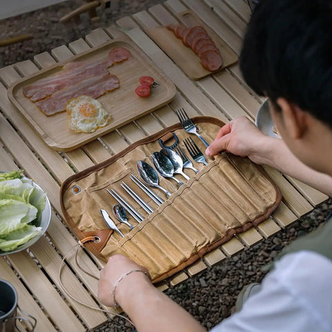 Trail Ready Stainless Steel Camping Utensil Kit With Spoon Fork Chopsticks being laid out on table during picnic