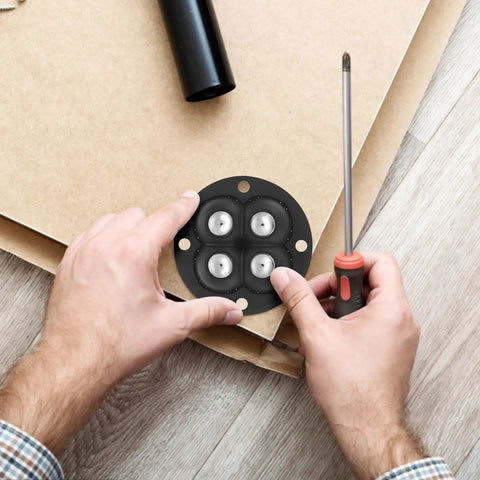 Hands placing Swivel Caster Wheels 360 Degree Rotation Self Adhesive 12pcs Mini on a surface with a screwdriver.
