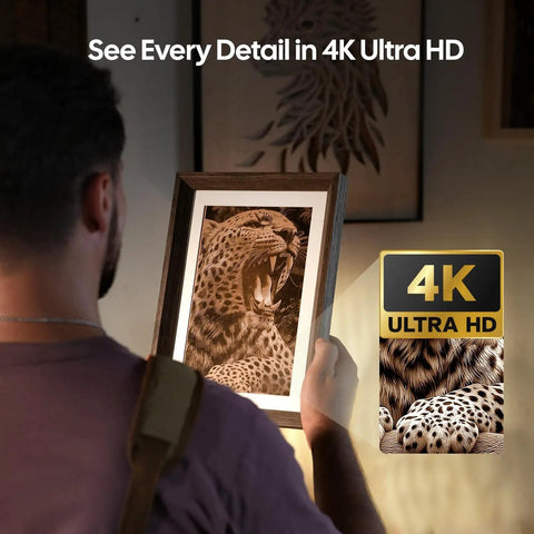 Person holding a 4K Ultra HD print of a roaring leopard in a wooden frame, showcasing the detail achieved with engraving technology.
