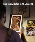 Man admiring a framed 4K Ultra HD engraving of a roaring leopard, showcasing intricate details.