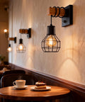 Industrial Cage Wall Sconce With Dimmer Switch And On Off Control, Farmhouse Black Metal Lamp With Painted Wood Holder in cafe setting