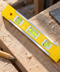 Spirit Level, Aluminum Alloy, yellow with three bubbles, placed on wooden surface for accurate leveling.