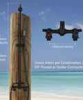 Wall Mount Outdoor Shower Kit With Handheld Spray Rugged Brass And Stainless Steel Fixtures In Matte Black installed on beach