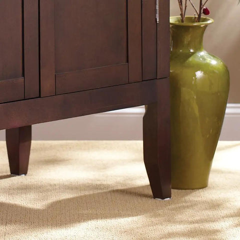 Peel And Stick Furniture Sliders Value Pack For Carpet Floors under a wooden cabinet leg for easy movement on carpet.