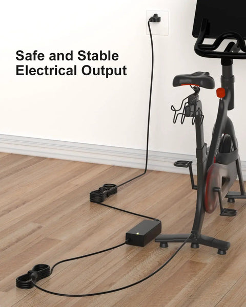 Peloton Replacement Power Cord 12V 5A AC DC Charger connected to bike with 7.5 foot long cable, showing electrical outlet