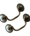 Six Pack Vintage Bail Drawer Pulls In Antique Brass, 3-3/8 Inch Hole Centers, shown in a close-up with rustic design details