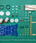 Components of 5 Pack D2-5 Smart Car Kit For Soldering And Line Following Robot Build laid out on green background