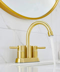 Gold Finish Bathroom Faucet With Dual Handles 360 Degree Rotating Stainless Steel Vanity Lavatory Sink Mixer Lead Free Modern Design Double Handle Commercial Style For Bathroom Sink Easy Operation And Clean Look installed on white marble sink.