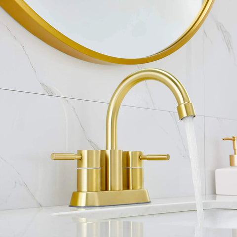 Gold Finish Bathroom Faucet With Dual Handles 360 Degree Rotating Stainless Steel Vanity Lavatory Sink Mixer Lead Free Modern Design Double Handle Commercial Style For Bathroom Sink Easy Operation And Clean Look installed on white marble sink.