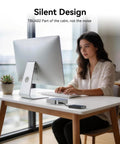 Woman working on a computer at a desk with a Blazing Fast 40Gbps NVMe M2 SSD Enclosure Handles Up To 8TB beside her.