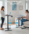 Two women using 32 Inch On Wheels Overbed Desk With Cup Holder And Height Adjustable Pneumatic Lift Rolling Computer Cart in home office.