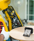 High Amperage Electric Vehicle Charging Connector Slick Fixed Base Heavy Duty Coupler mounted on a motorcycle, highlighting solid design.