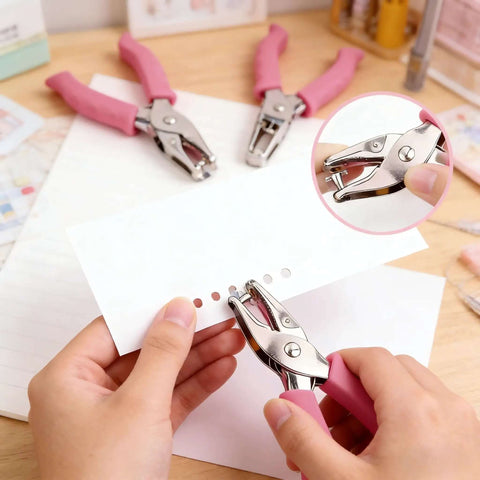 Two Piece Hole Punch Set Circle Punches One Quarter Inch And One Eighth Inch With Pink Soft Grip Handles being used on paper