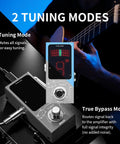 Ultra Compact Tuner Pedal With Pitch LED Indicator For Electric Guitar And Bass next to guitarist, showing tuning modes on blue stage.
