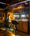 Rustic Farmhouse Chandelier 4 Light Industrial Pendant Lighting with Adjustable Height installed above a bar