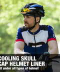 Cyclist wearing blue and black helmet with Cooling Skull Cap Liner For Helmets Lightweight Mesh Under Helmet Cap For Cycling And Motorcycle.