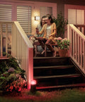 Calla White And Color Ambiance Outdoor Pathway Light Base Kit illuminating stairs with red light beside porch garden at night