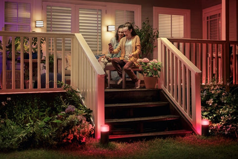 Calla White And Color Ambiance Outdoor Pathway Light Base Kit illuminating stairs with red light beside porch garden at night