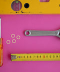 Copper Washer Kit 40 Pcs Set For Oil Drain Plugs And Hydraulic Seals Built To Last with screwdriver and wrench on pink background.