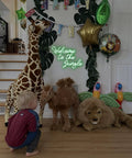 Welcome To The Jungle Neon Sign Green LED Light For Wall Decor USB Powered Jungle Theme Decor For Garden Home Entryway Front Porch Totally Lit Neon Letter Sign, surrounded by plush jungle animals