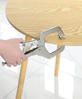 Workhorse 11 Inch Locking C Clamps 4 Pack Heavy Duty Steel With Swivel Jaw Pad One Hand Quick Release Mechanism gripping a wooden table leg.