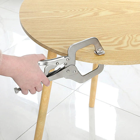Workhorse 11 Inch Locking C Clamps 4 Pack Heavy Duty Steel With Swivel Jaw Pad One Hand Quick Release Mechanism gripping a wooden table leg.