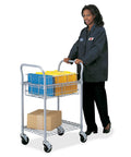 Beat The Paper Stack With This Heavy Duty Mobile Mail Cart, Smooth Rolling Locking Wheels, Chrome Wire Basket, Bottom Shelf, Holds 75 Legal Folders, Gray with person pushing cart filled with folders.
