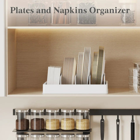 Plates and napkins organizer on shelf with multiple sections holding plates and napkins, white container in kitchen setting.