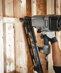 Hand using Pneumatic 21 Degree Full Round Head Framing Nailer with nails 2 to 3-1/2 inch length for wooden framing