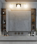 Three Light Mid Century Vintage Bathroom Vanity Light Fixtures Over Mirror Black and Gold Industrial Vanity Lights With Milk White Glass Globe For Farmhouse Bath Lighting mounted above mirror in modern decor bathroom.