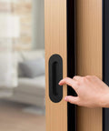 6 Inch Oval Black Pocket Door Pull Heavy Duty Stainless Steel Finger Flush Pull For Closet And Sliding Barn Doors 2 Pack Durable Rust Resistant 304 Stainless Hardware installed on wooden door