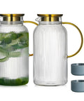 Two Piece Glass Pitcher Set Including Secure Glass Lid And Cushioned Anti Slip Silicone Base For Kitchen Counter Safe Serving Heavy Duty Water Jug Hassle Free Dispensing For Iced Coffee And Fresh Juice with green herbs inside one pitcher.