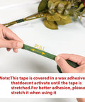 Hands stretching green floral tape from DIY Floral Arrangement Kit With Green Floral Tape And Wire For Boutonniere And Bouquet.