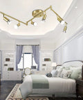Golden Finish 6 Light LED Track Lighting Kit With Rotatable Heads in bedroom, modern foldable design.