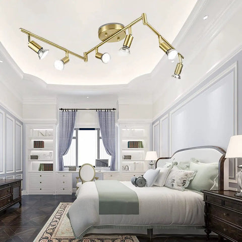 Golden Finish 6 Light LED Track Lighting Kit With Rotatable Heads in bedroom, modern foldable design.
