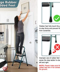 Person using Five Foot Folding Step Ladder with Wide Anti Slip Pedals, Heavy Duty Steel Build, in kitchen, green, with stabilizers and padded feet.